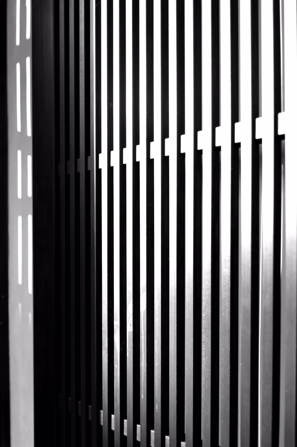 The wooden lattice of the front, backlit from the lane